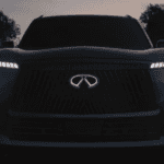 Front view of a 2026 INFINITI QX80 full-size luxury SUV showcasing illuminated emblem and piano key LED daytime running lights at Ramsey INFINITI dealership on Route 17