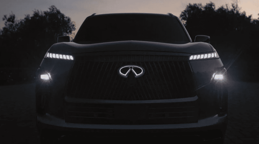Front view of a 2026 INFINITI QX80 full-size luxury SUV showcasing illuminated emblem and piano key LED daytime running lights at Ramsey INFINITI dealership on Route 17