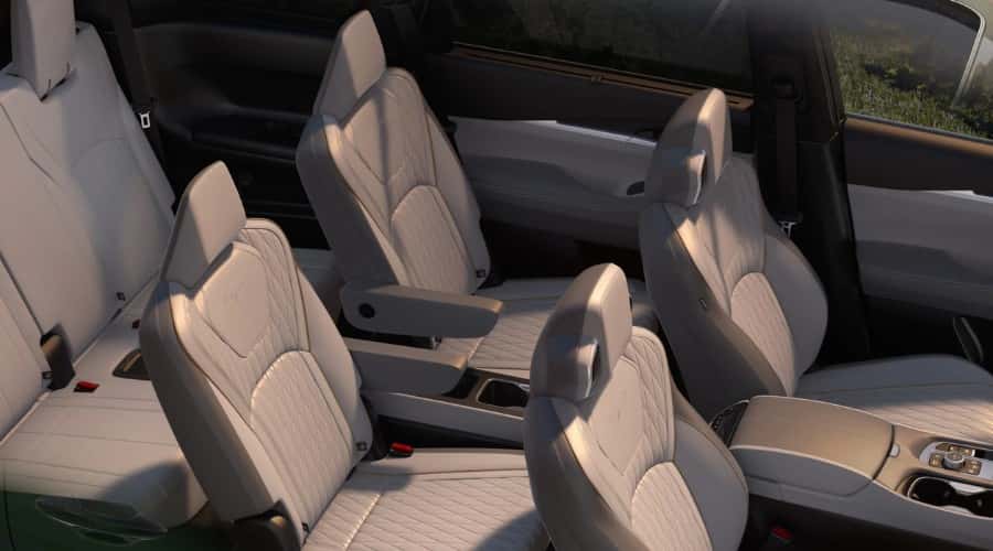 Overhead interior view of the 2026 INFINITI QX60 three-row luxury SUV showing quilted Stone Gray semi-aniline leather seats, second-row captain's chairs, and spacious family seating for Bergen County carpools near Ramsey, NJ.