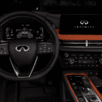 Interior cockpit of a 2026 INFINITI QX65 showcasing the digital instrument cluster displaying ProPILOT Assist 2.1 driver assist settings, leather steering wheel with driver assistance buttons, and central INFINITI InTouch display screen at Ramsey INFINITI in Bergen County, NJ