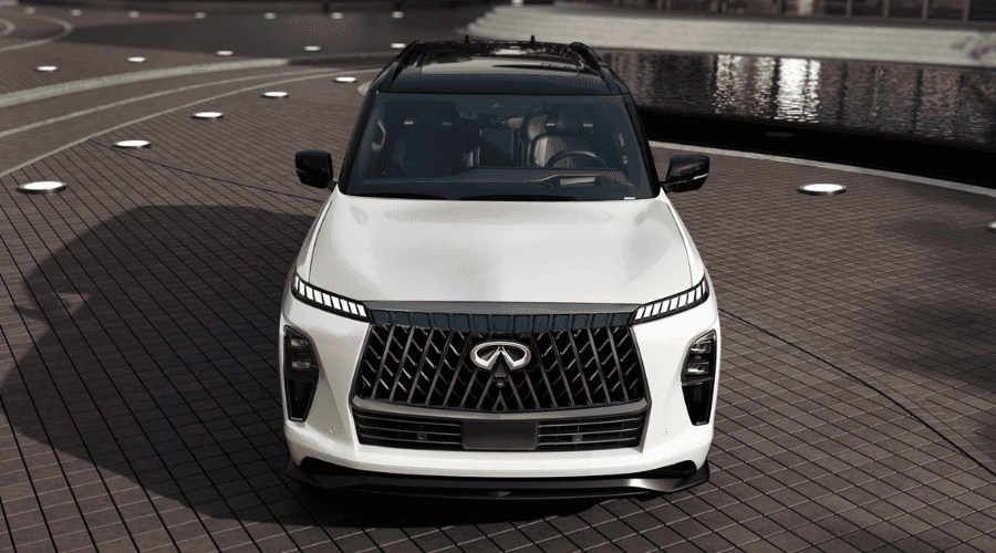 Front view of a white 2026 INFINITI QX80 with black contrast roof featuring an illuminated emblem, LED DRLs, and front camera array for wet weather safety at Ramsey INFINITI near Route 17 in Ramsey, NJ.
