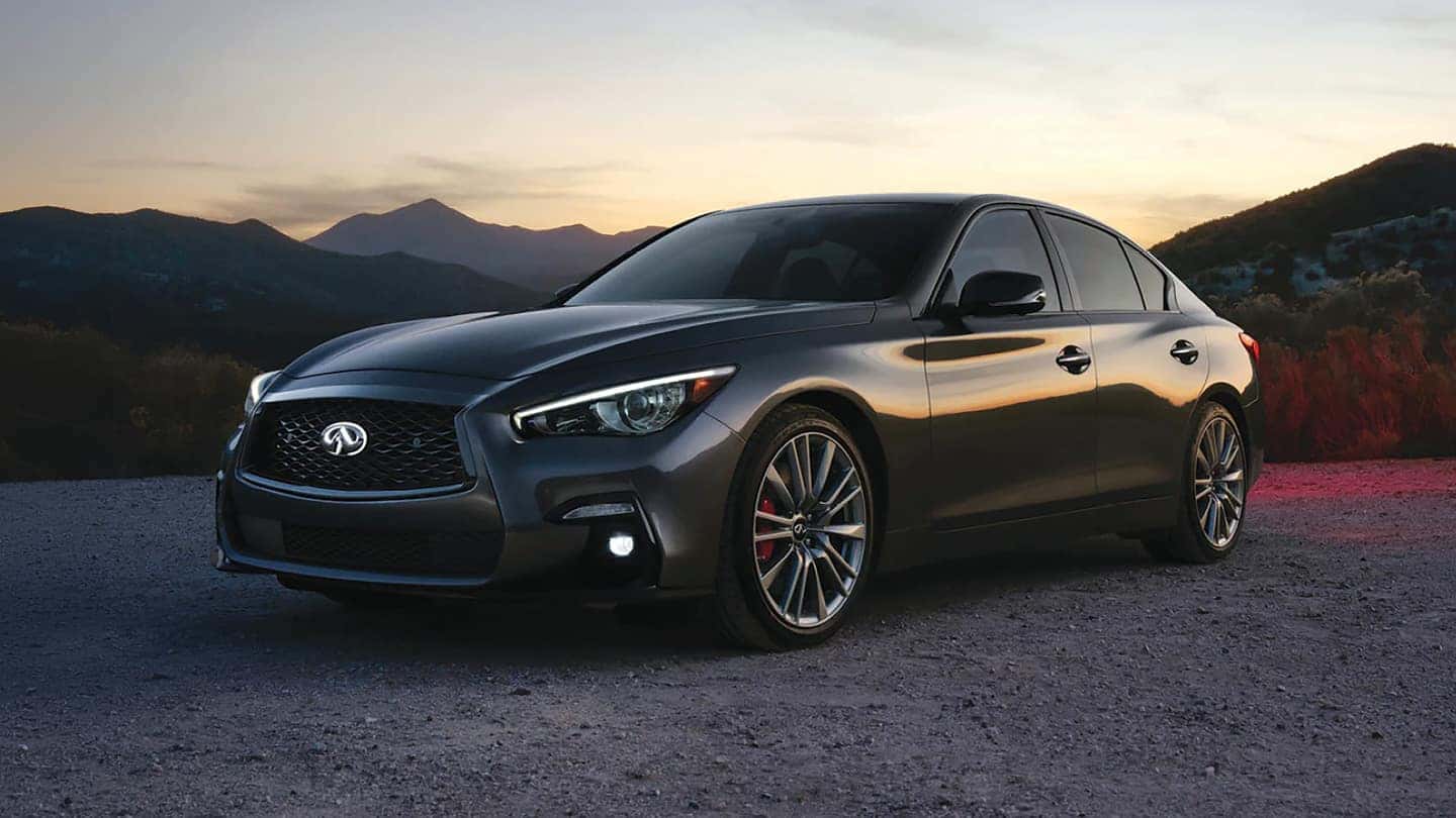 Front profile of a Certified Pre-Owned INFINITI Q50 luxury sport sedan on Route 17 in Ramsey, New Jersey showing its athletic stance and gloss black grille.