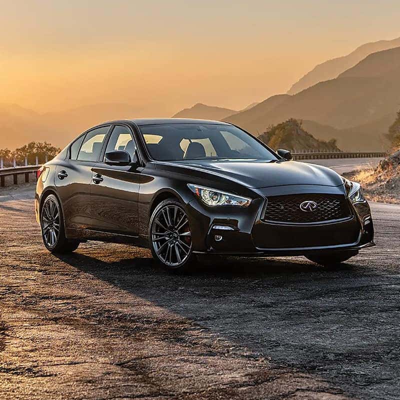 Rear three-quarter view of a Certified Pre-Owned INFINITI Q50 showing dual exhaust tips and LED taillights.