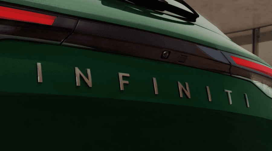 Close-up view of the rear liftgate on a green 2026 INFINITI QX60 showing the chrome INFINITI block lettering badge, slim LED taillights, and integrated rear camera at Ramsey INFINITI in New Jersey.