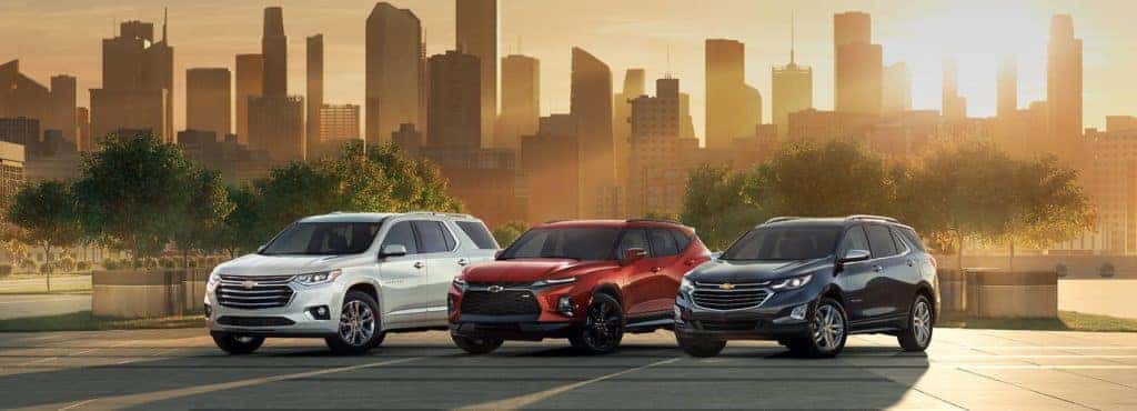 Chevrolet Lineup Against a City Skyline at Sunset