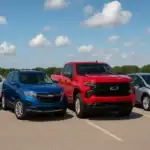 Chevrolet vehicles lineup featuring a white Trax, blue Equinox, red Silverado truck, and silver Bolt EV parked under a bright blue sky.