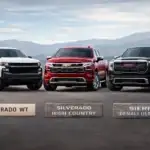 Trucks in front of mountain range