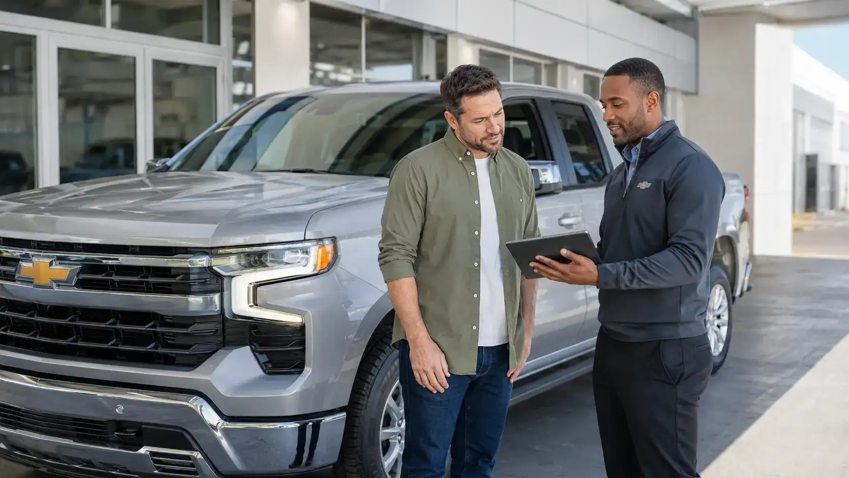 Modern showroom with Chevrolet truck and staff
