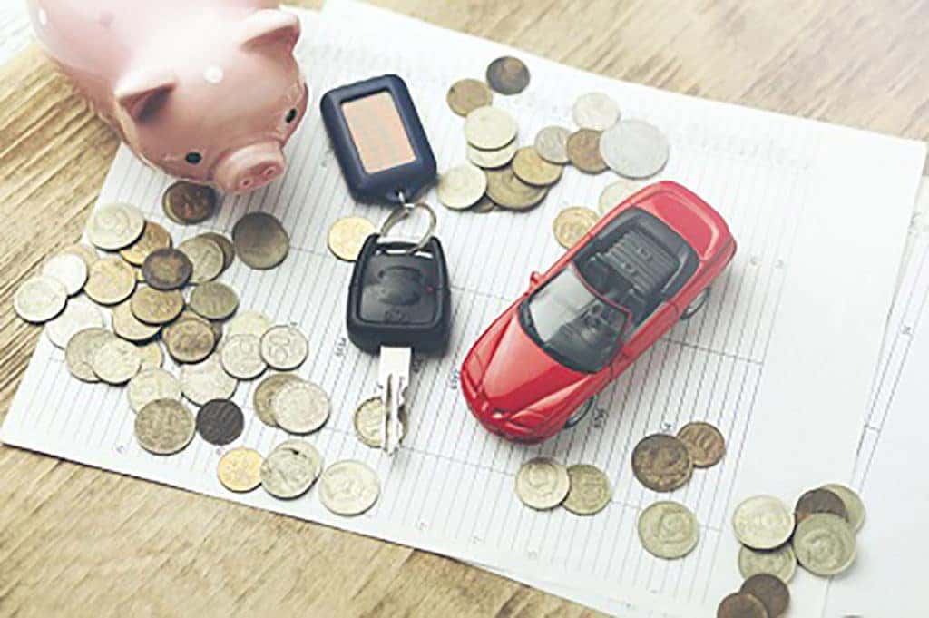 Car key, toy car, and coins scattered