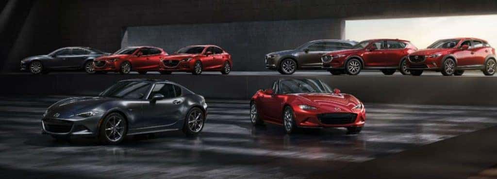 Red and black Mazda cars in a showroom