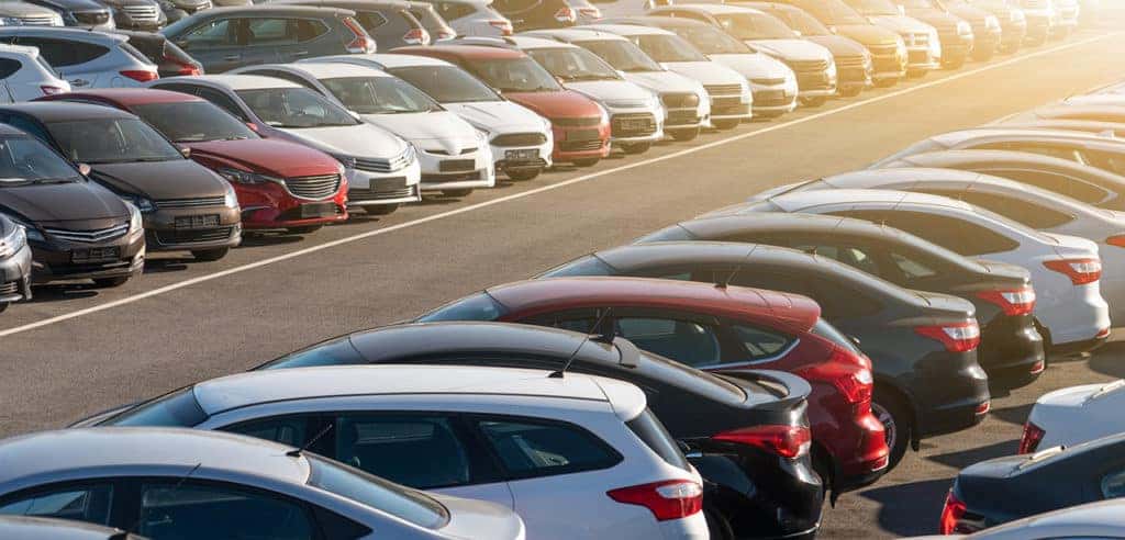 Rows of used cars on a lot.