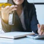 Car key on hand for vehicle sales agreement,Car finance and loan concept
