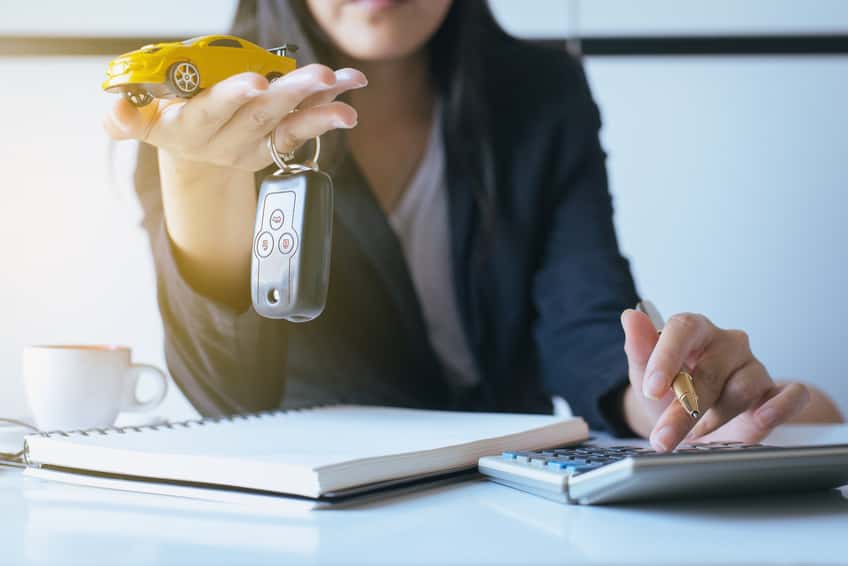 Car key on hand for vehicle sales agreement,Car finance and loan concept