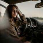 Teenage girl in the front seat of a car