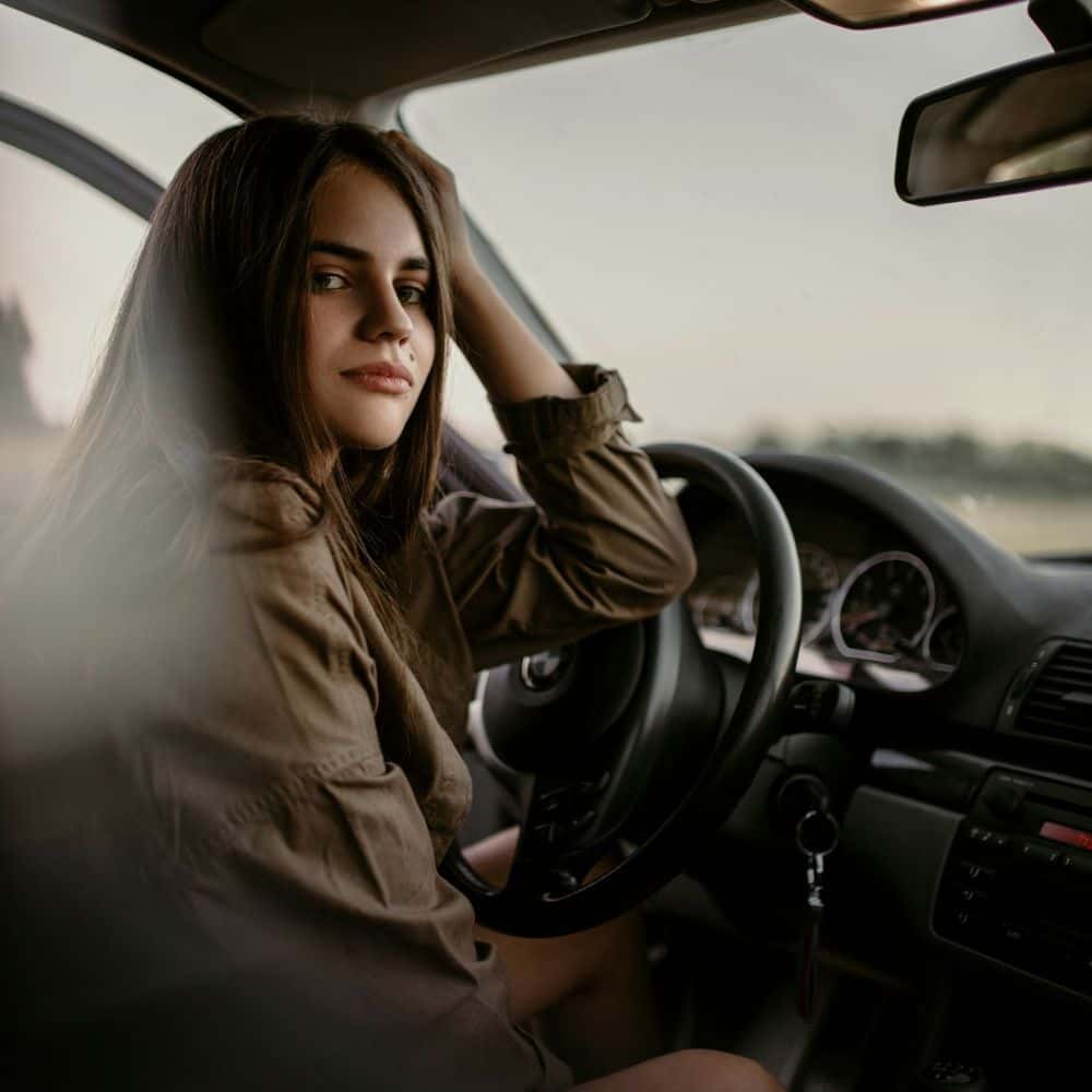 Teenage girl in the front seat of a car