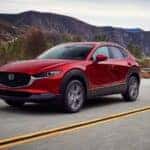 Red 2025 Mazda CX-30 driving on the highway