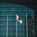 Japanese flag in front of modern building