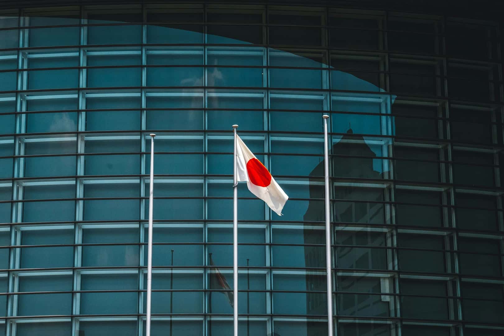 Japanese flag in front of modern building