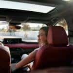 Woman inside Mazda CX-70 with red seats