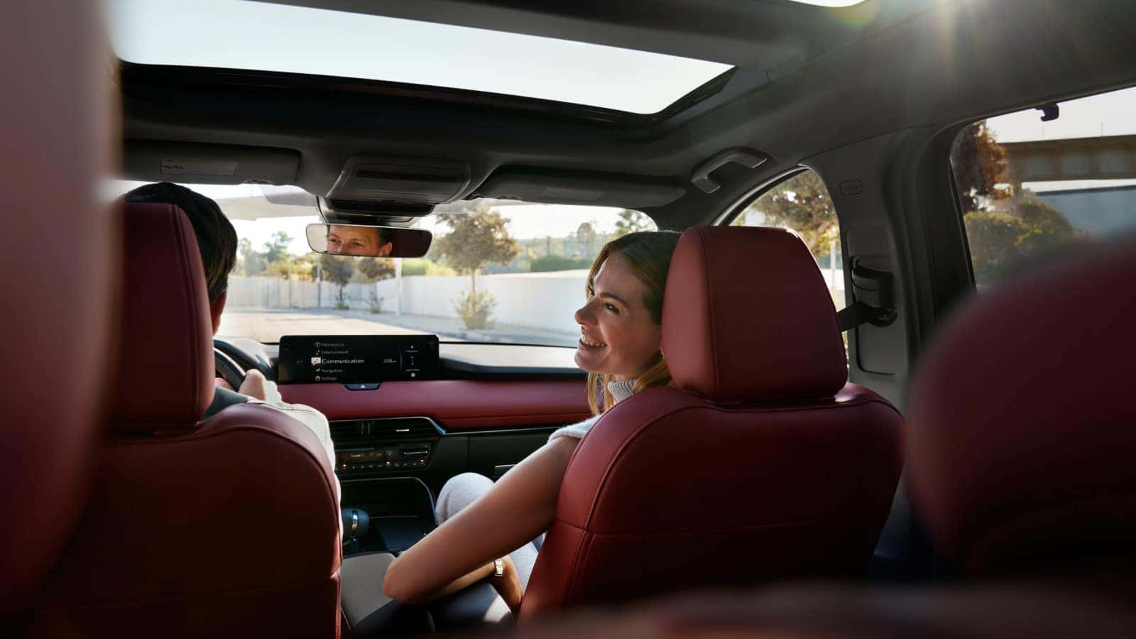 Woman inside Mazda CX-70 with red seats