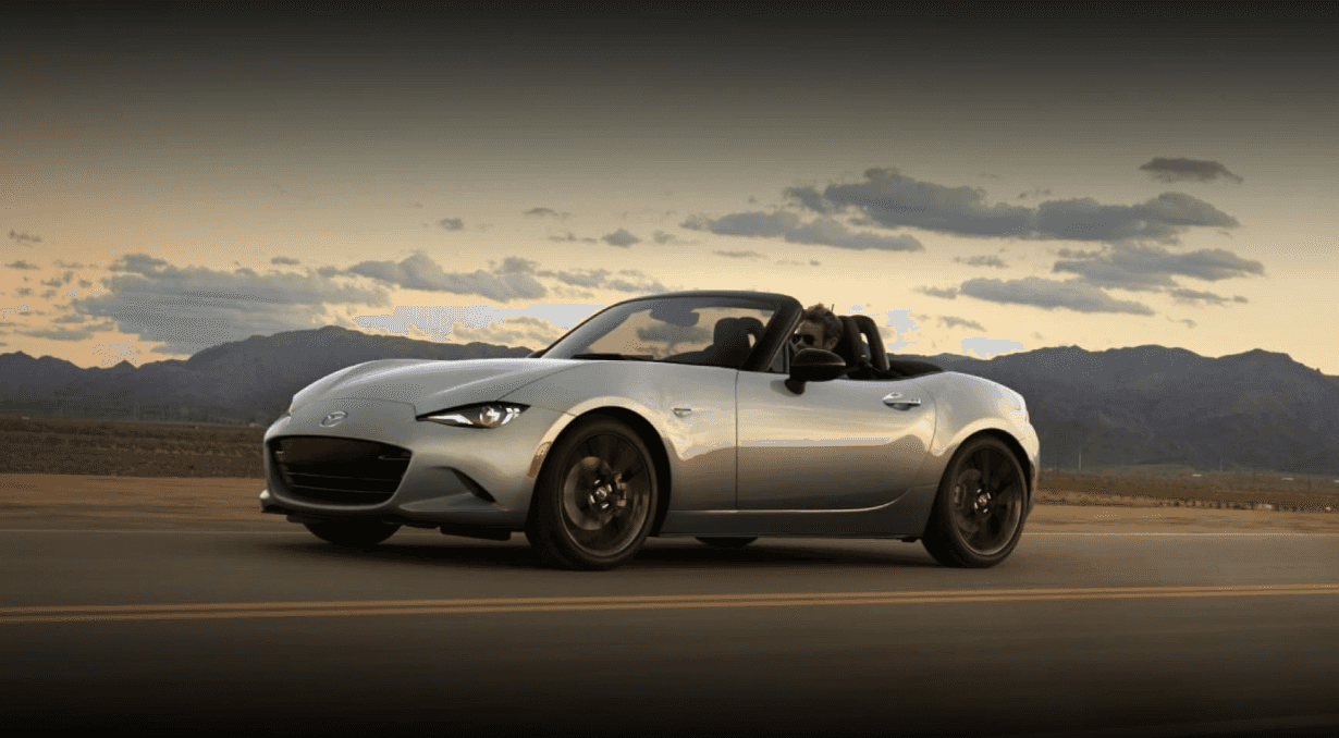 mazda-miata-grey-driving-on-road