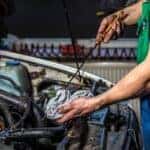 oil change technician with dipstick