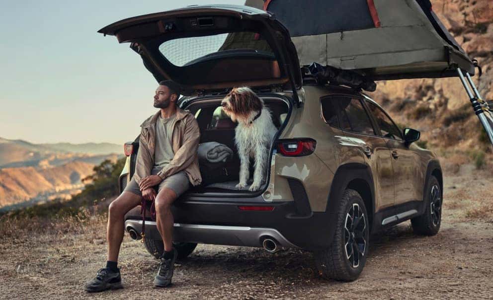 2027 Mazda CX-50 rear three-quarter with open liftgate and roof platform