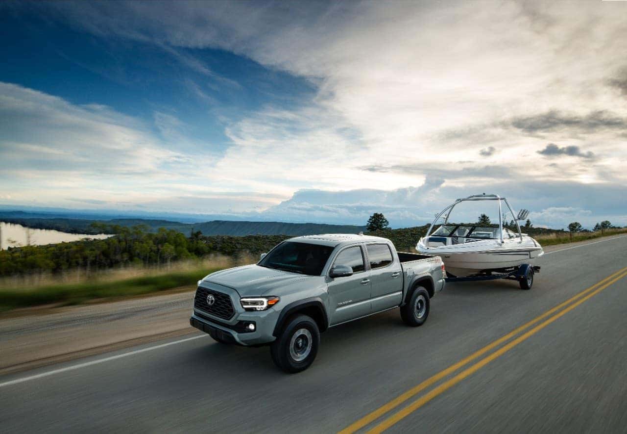 Toyota Tacoma towing boat near lake