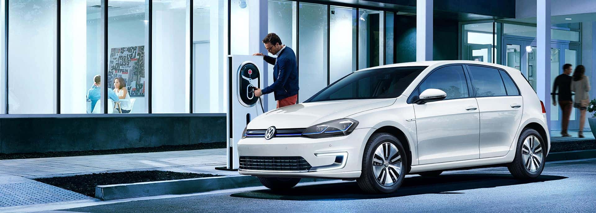 Man charging the 2019 VW e-Golf at a charging station