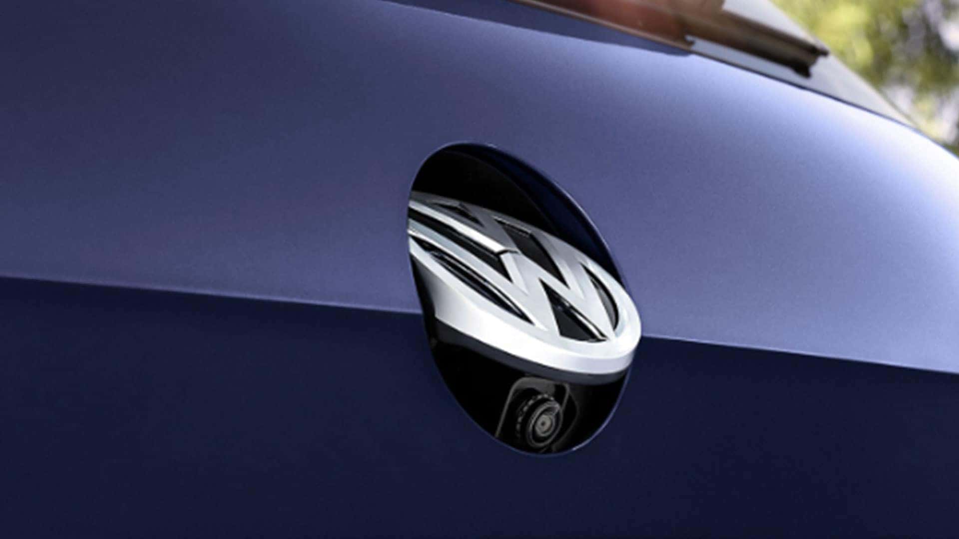 2019 VW e-Golf rearview camera peeking out from beneath the VW logo.