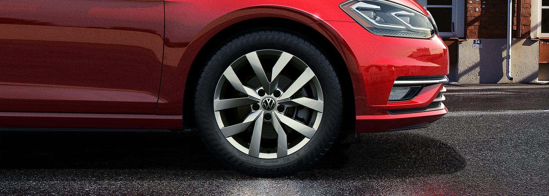 A close-up of the wheel on a red 2019 VW Golf