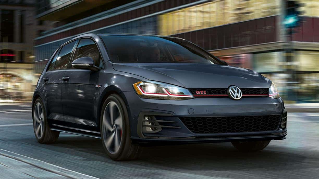 2019 VW Golf GTI driving through a city.