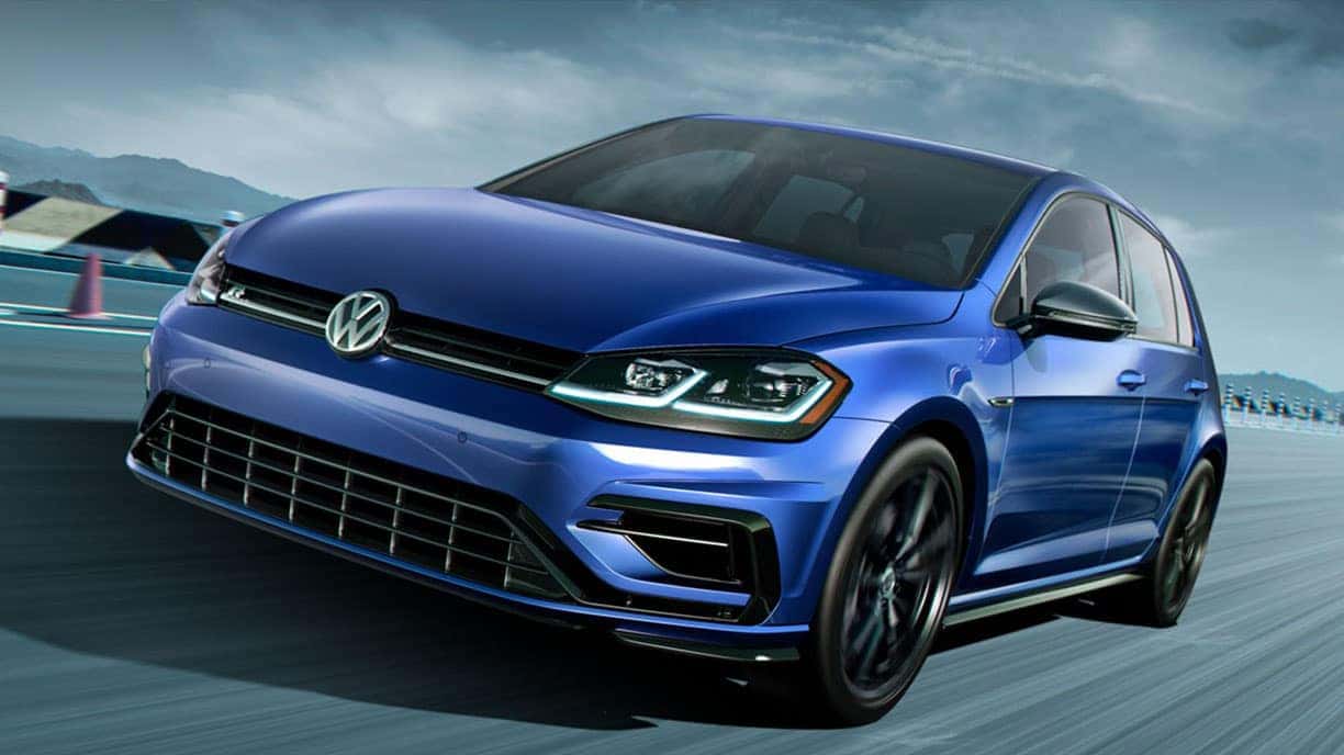 Dynamic photo of a blue 2019 VW Golf R on a race track