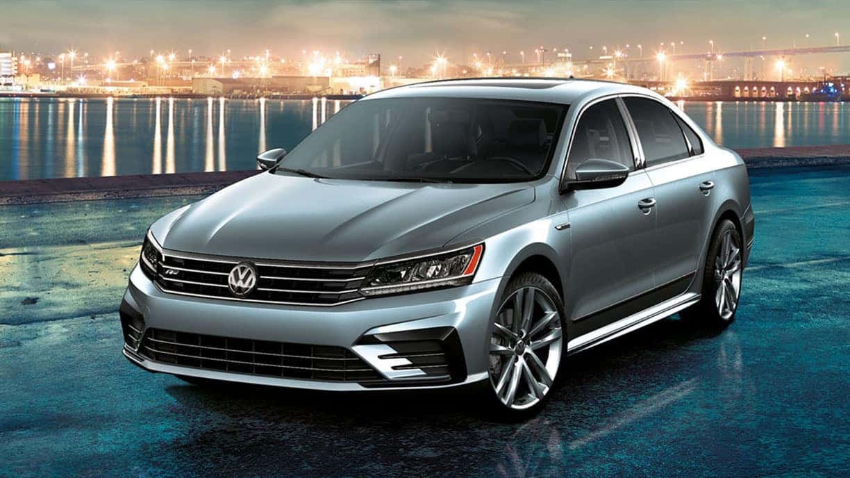 2019 VW Passat parked by the waterfront at night.