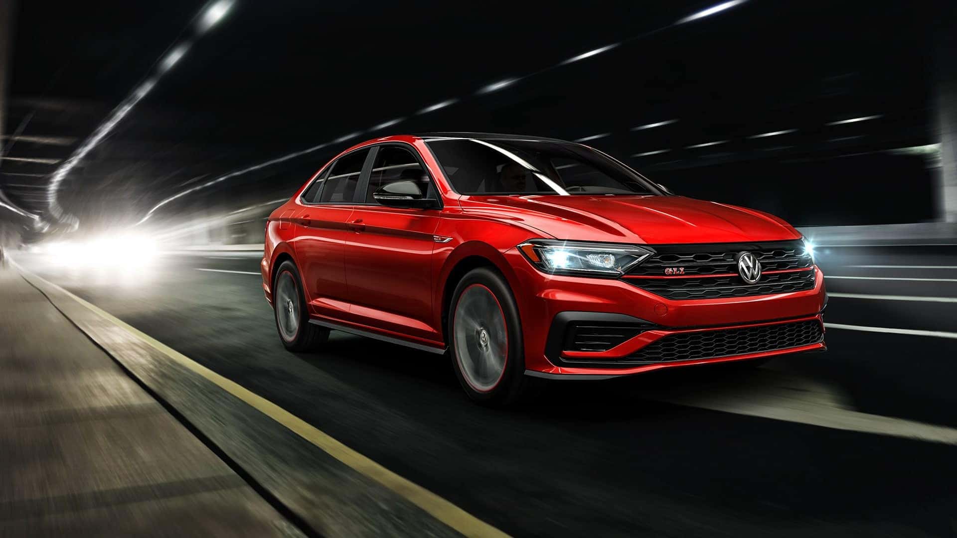 Red Jetta GLI driving through tunnel