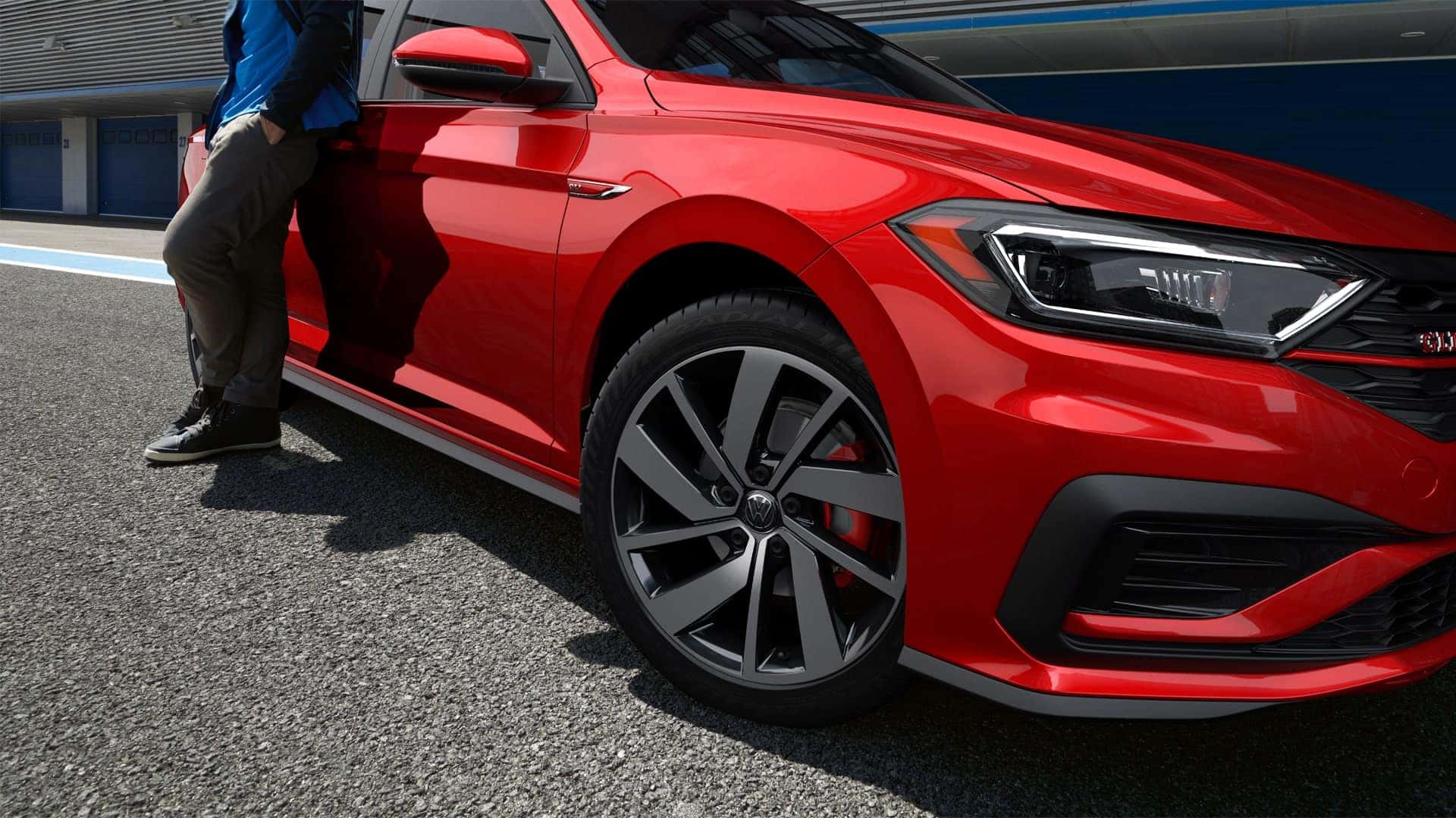 Red VW Jetta GLI with close-up of wheels